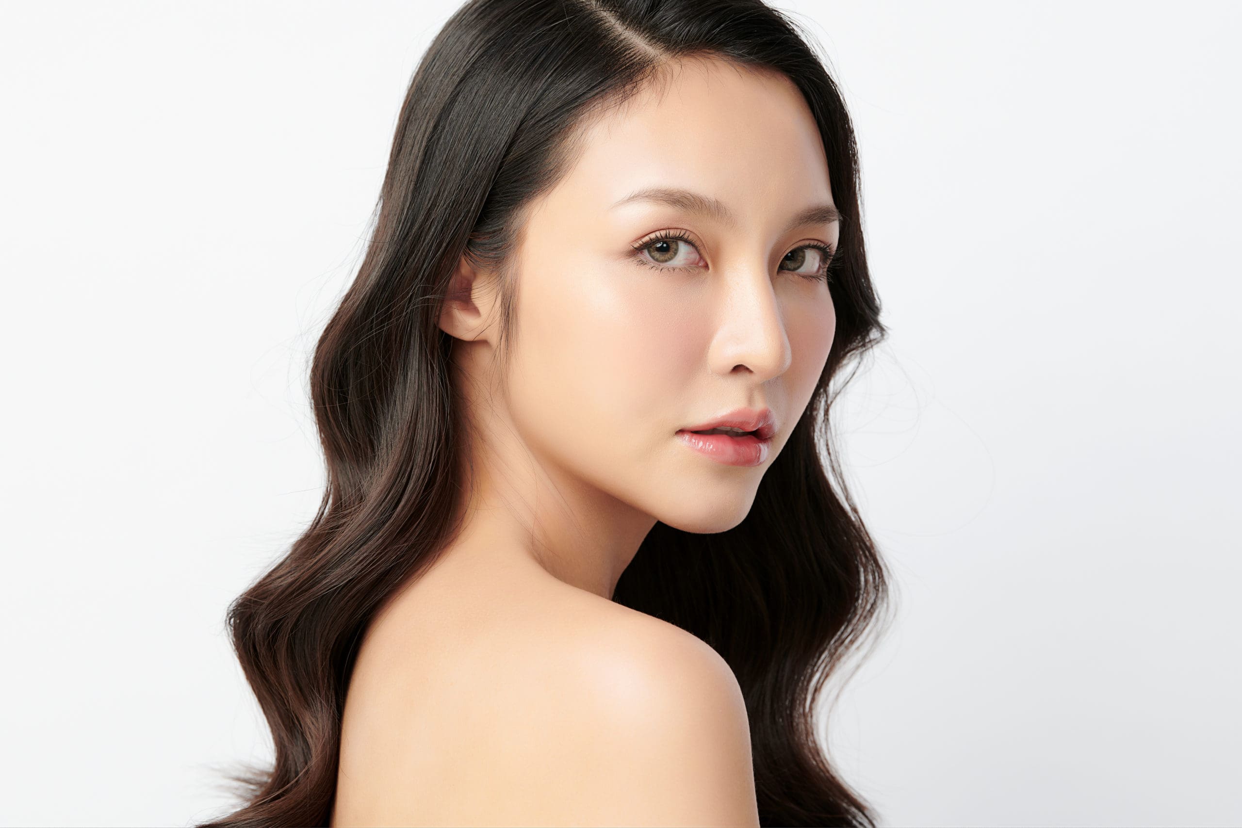 Beautiful young asian woman with clean fresh skin on white backg